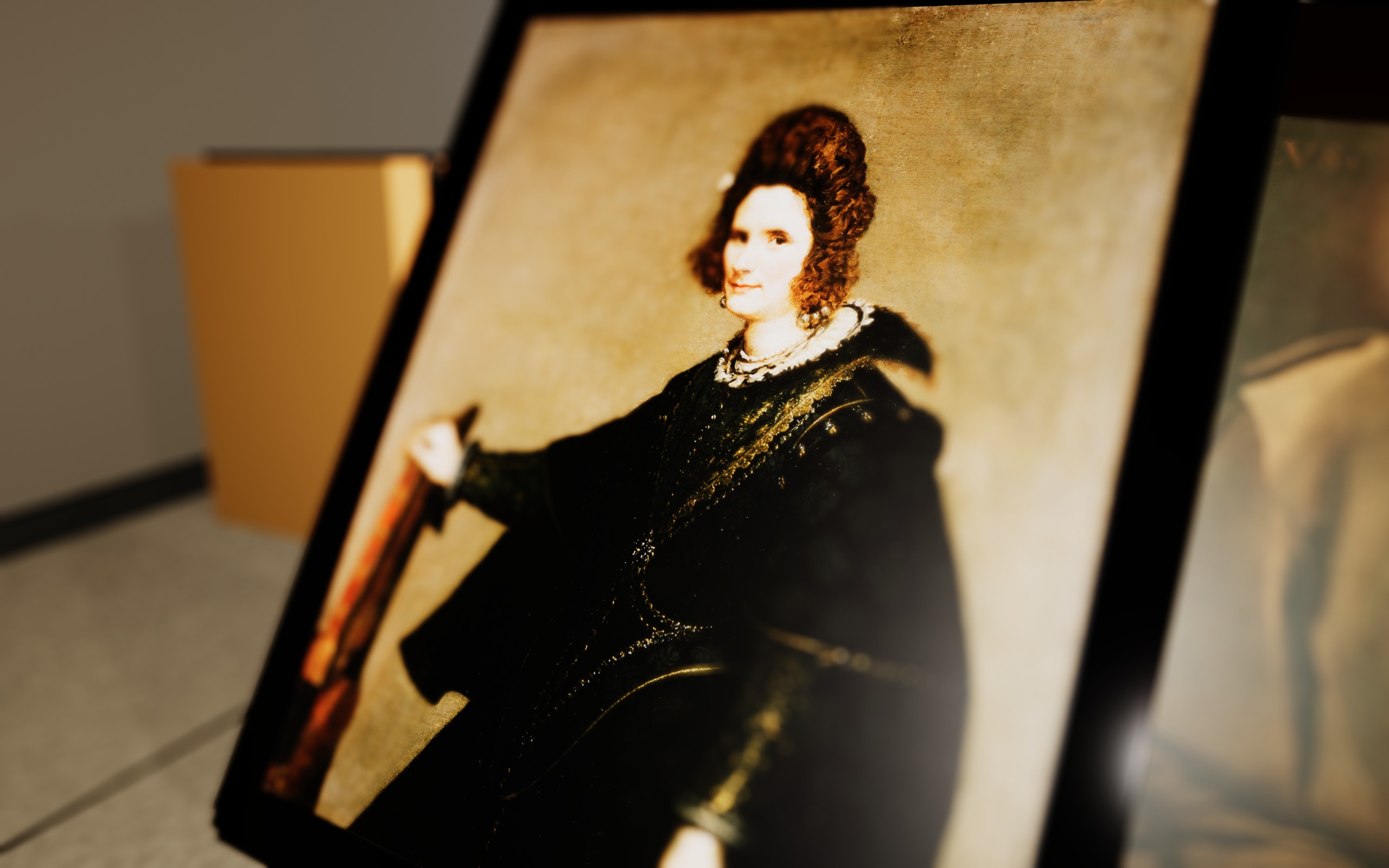 An oblique close-up of a painted portrait with a very shallow plane of focus.